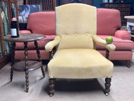 A FINE YELLOW FABRIC UPHOLSTERED COUNTRY HOUSE ARMCHAIR IN THE MANNER OF HOWARD