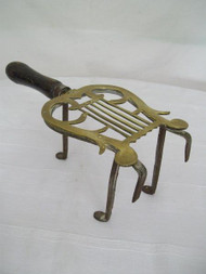 A GOOD SIZED ANTIQUE BRASS AND IRON FIRESIDE TRIVET