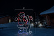 Red, white and blue LED display of Santa checking his list with dimensions 5' by 5'11"