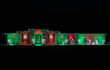 A house covered in red and green lights with candy cane light displays.