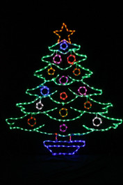 Large decorated  green LED light Christmas tree with red, white, and blue ornaments and a star on top