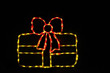 LED light display of a yellow Christmas package with a red ribbon