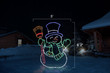 Jolly LED snowman with a blue top hat, green scarf and red broom with dimensions 5' by 6'2"