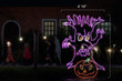 Eerie purple tree LED light display with an orange jack-o-lantern with dimensions 4'10" by 7'