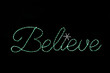 Green LED lights sign saying "Believe"