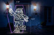 Scaled light display of a mummy coming out of a coffin. 4' 9" by 6' 5".