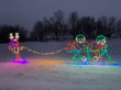 Light display of elves on a bicycle.