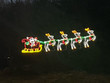 Animated LED red, white, yellow and green waving Santa light display with dimensions 7'5" by 5'7"