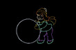 Yellow, green, purple and red LED light display of a girl rolling a white snowball