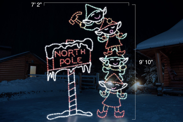 Animated LED sign of four green and red elves stacked on top of one another hammering a red and white "North Pole" sign into the ground with dimensions 7'2" by 9'10"