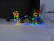 Light display of a boy and girl roasting a marshmellow.