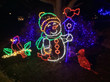 A snowman light display in a yard.