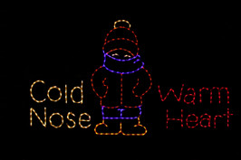 LED sign saying "Cold Nose Warm Heart" with a bundled up child in the middle 