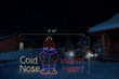 LED sign saying "Cold Nose Warm Heart" with a bundled up child in the middle with dimensions 7'11" by 4'5"