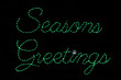 Green LED light display of a sign saying "Seasons Greetings"