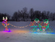 Light display featuring bicycling elves pulling a snowboarding reindeer.