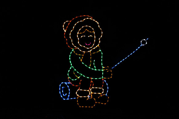 Light display of a girl roasting a marshmellow.