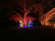 Light display of a boy and girl roasting a marshmellow.