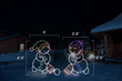 Two animated LED snowmen with colorful hats playing broomball.  Dimensions of left snowman are 4' by 4'3" and dimensions of right snowman are 3'8" by 4'5" .