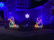 Snowmen light displays in a yard.