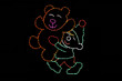 Light display of an elf holding a bear.