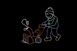 Light display of a man using a snowblower.
