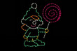 Light display of an elf with a lollipop.