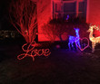 A "Love" light display in a yard.