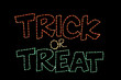 A Halloween wireframe LED light reading, "trick or treat" in orange, white and green. 