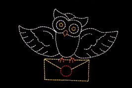 Light display of an owl holding a letter.