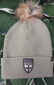 Stay cozy and stylish this winter in our Warroad faux fur pom beanie. Embellished with a leather SSM Shield logo patch.