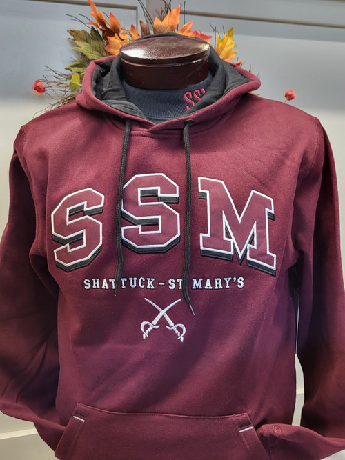 The maroon  Shattuck – St. Mary’s  "I'll Be Back" Hoodie is a spirited hoodie designed for Sabres fans.  The hoodie is made from a comfortable and warm fabric to provide a cozy fit during cooler weather.

 70% Cotton 30 % Polyester, 100% Cotton hood with drawstring, appliqued and embroidered  front logo, front kangaroo pockets.

Machine wash, tumble dry.