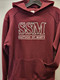 Badger Sport youth hooded sweatshirt. Screened center chest SSM logo.  8 oz./yd², 60/40 ring-spun cotton/polyester fleece fabric. Spandex reinforced rib knit cuffs and waistband. Pouch pocket with headset opening.