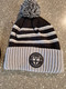 Shattuck-St. Mary's Figure Skating Patch knit Cuffed beanie. Three-stripe design with POM on top.