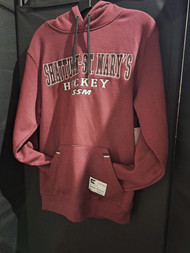 Maroon hockey hoodie featuring Shattuck-St. Mary's Hockey SSM embroidered in black and white lettering on the front. Drawstring hood with cuffed sleeves and waist. 70% cotton/30% polyester. Men's sizes small, medium, large and X-large.