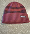 Knit cuffed beanie in maroon with black stripes. Featuring woven SSM label on front. One size fits all.