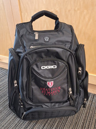 Ogio Metro backpack features back panel side-entry padded laptop pocket, large center storage area. Power cord and mouse storage, internal file sleeve. Weatherproof fleece-lined digital media/audio pockets with headphone exit port,. Adjustable sternum strap, deluxe organization panel. Features new Shattuck St. Mary's logo on front.

 