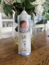 Hand foiled Baptism candle with blue tones and finished with a blue satin ribbon