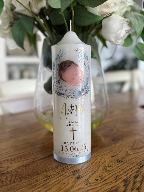 Hand foiled Baptism candle with blue tones and finished with a blue satin ribbon