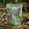 Nuprol RZR Airsoft BBs 6000R BIO Tracers 0.25g pouch on a mossy woodland floor with BBs scattered nearby