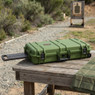 Nuprol Medium Premium Rifle Case with P&P Foam in Green on a wooden range bench, angled view with pull handle extended