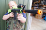 Guy with Zombie Army M4A1 electric bb gun in radioactive green 