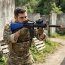 Double Eagle M83 B2 electric Semi Automatic bb gun in Blue aimed outdoors, with blue stock and orange barrel tip visible