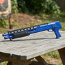 Double Eagle M309 Pump Action Shotgun in Blue, side view on an outdoor wooden picnic table