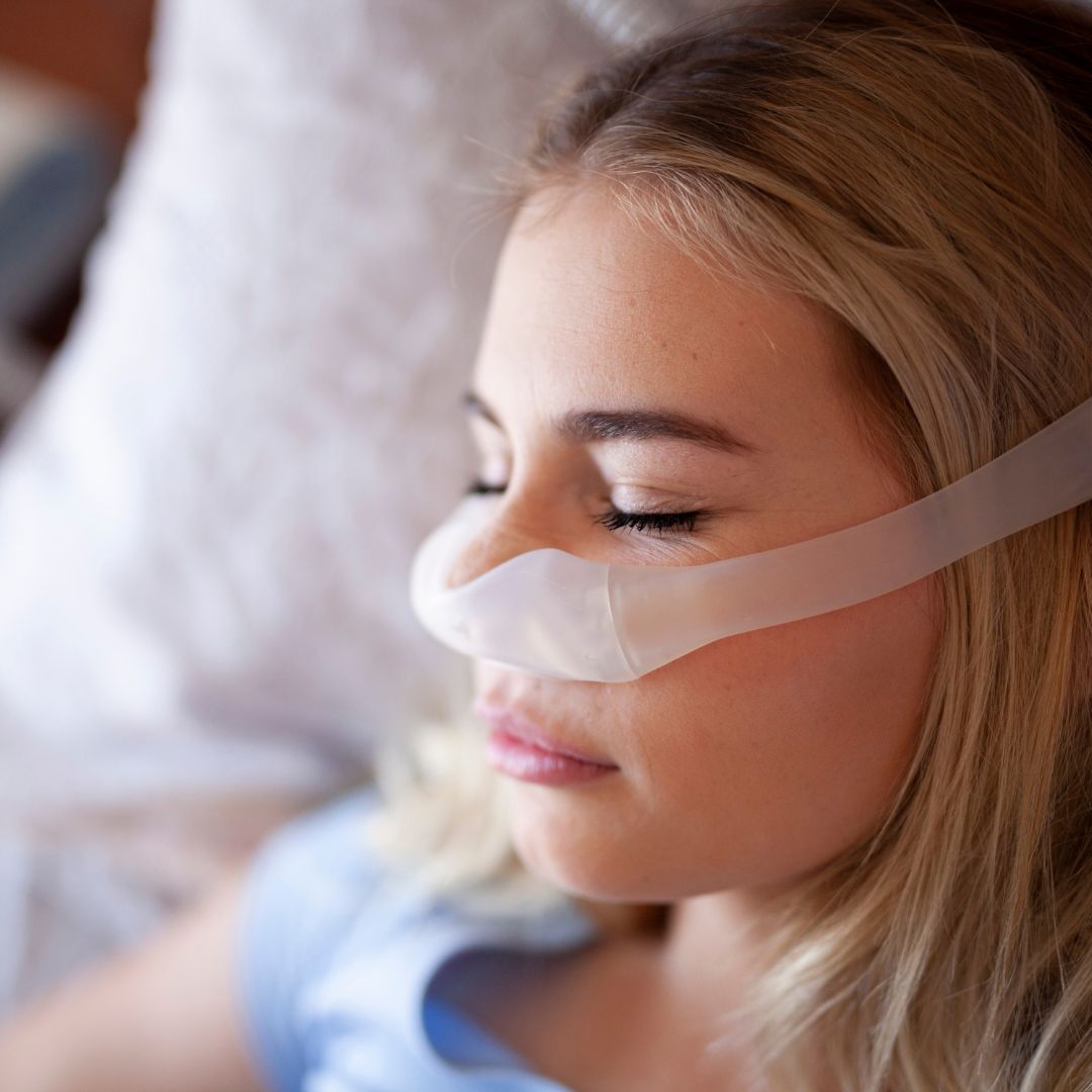 A woman wearing a CPAP mask