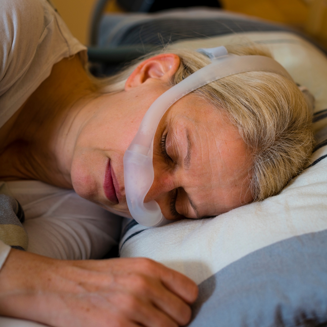 Woman sleeping with a BiPAP machine