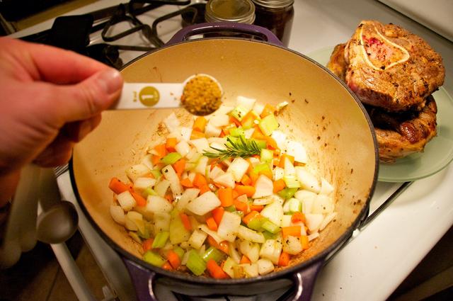 chopped vegetables coated with olive oil and italiano pronto in dutch oven