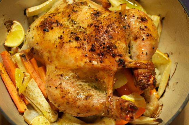 cooked whole chicken in dutch oven with parsnips and carrots