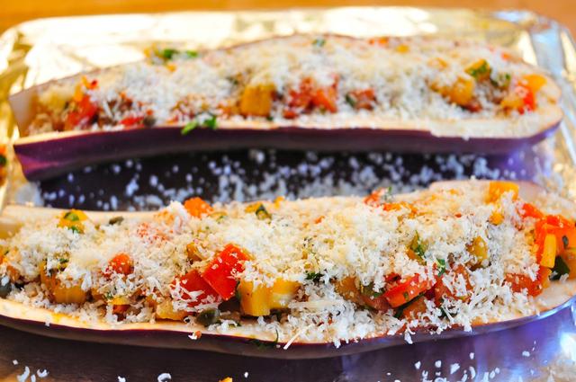 topped parmesan cheese on stuffed eggplant boat