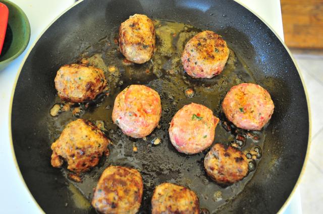 meatballs brown on a hot saute pan